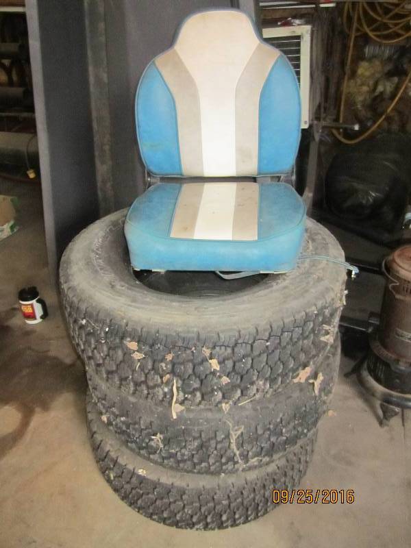 lot 35 image: Boat seat and 3 tires, good tread, ...