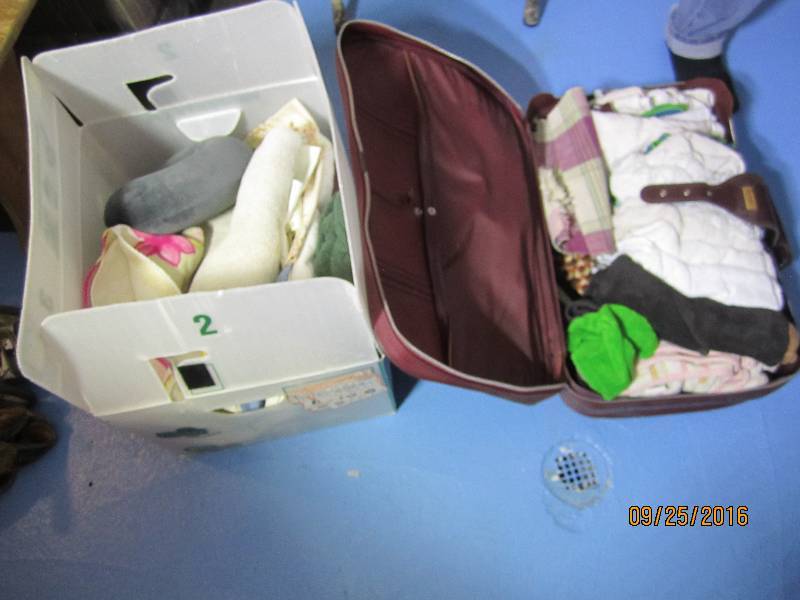 lot 91 image: Reusable plastic tote of towls, and...