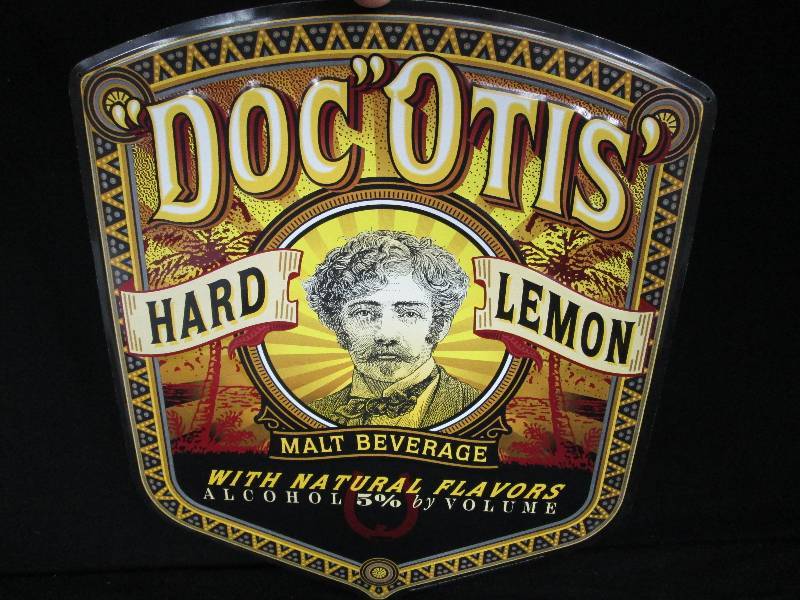 lot 93 image: Embossed DocOtis Hard Lemon Malt Beverage Tin Sign