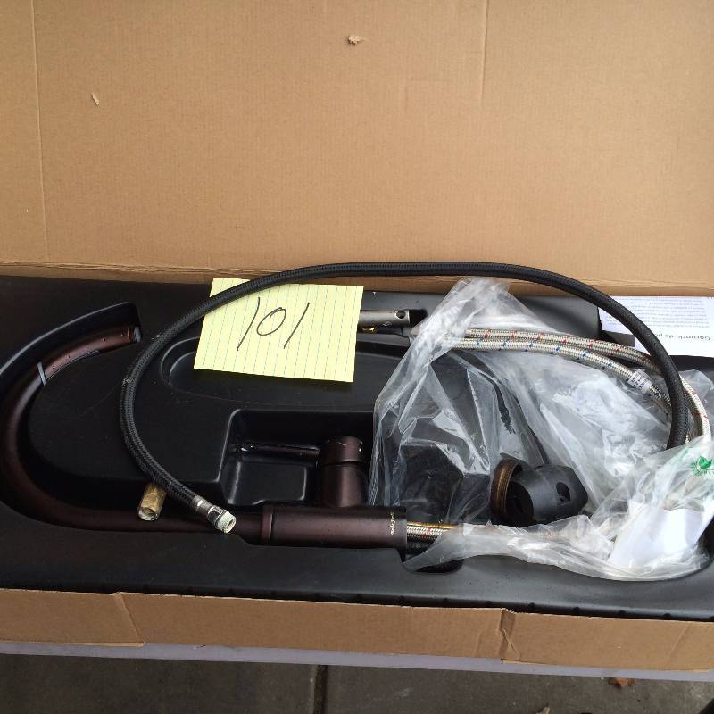 lot 101 image: Belle Foret Single Handle Pull out sprayer Kitchen Faucet in Oil Rubbed  Bronze in original pkg never used stock and actual pictures used to display item