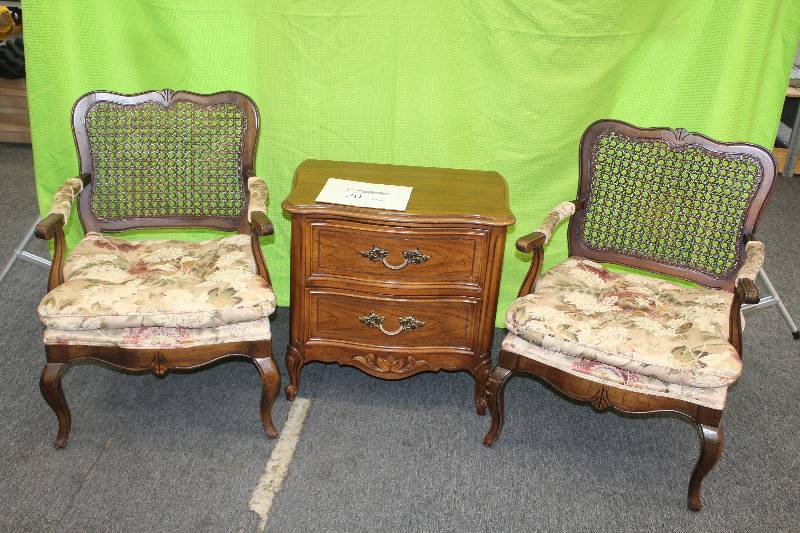 2 cane back chairs with plush seats and a 2 drawer all wood sitting table