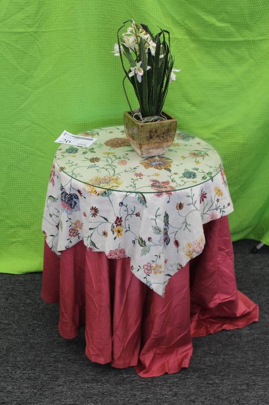 Parlor table with silk flower arrangement in glazed ceramic pot