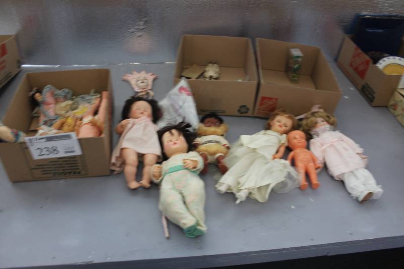 2 boxes of misc. dolls and doll clothes.