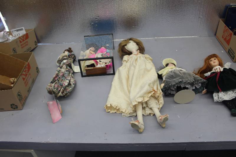 3 boxes of collectible dolls and some dollhouse items.