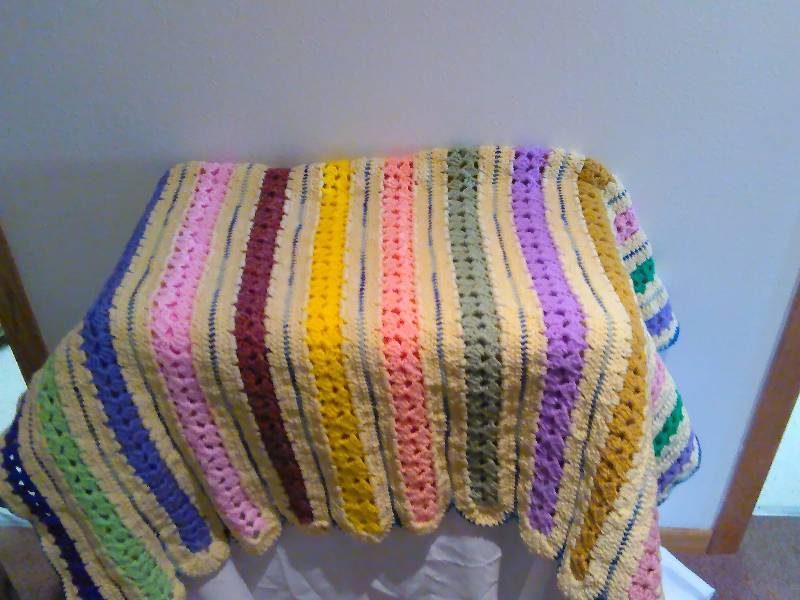 lot 7 image: Multi colored crocheted lap blanket