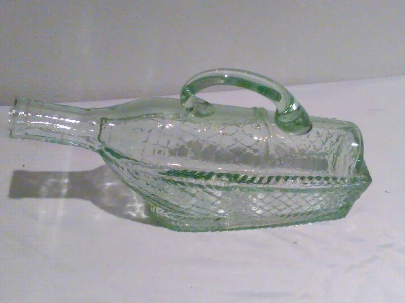 lot 46 image: Glass bottle in glass basket dcor