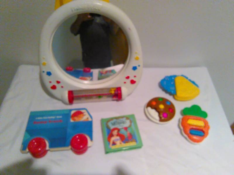 lot 107 image: Children Toddler Books, Fridge magnet and Fisher Price crib activity center