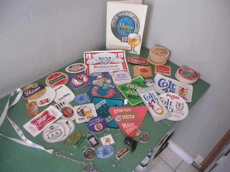 lot 25 image: VINTAGE LARGE BEER COLLECTIBLE GROUP - PATCHES,BUTTONS,STICKERS,COASTERS,KEY CHAINS - SEE PICTURES