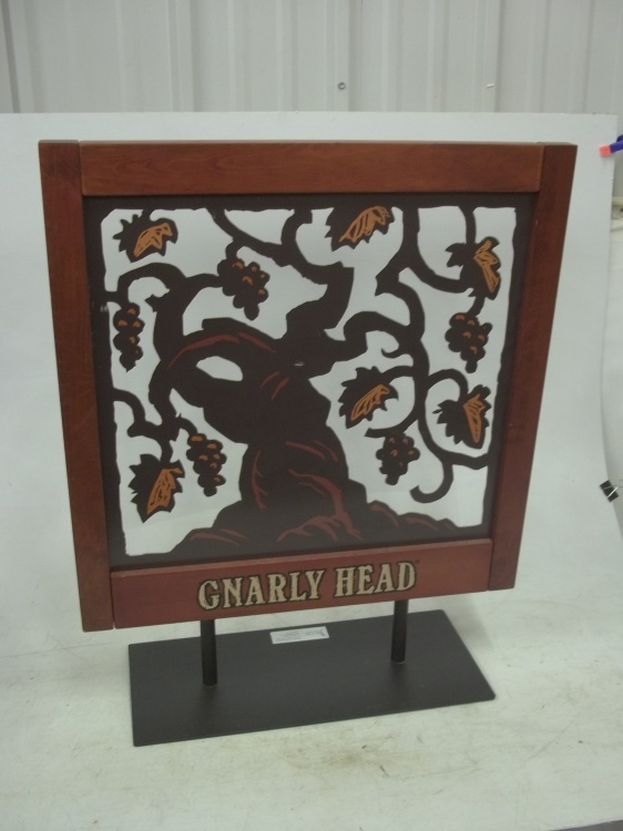 lot 16 image: Double sided gnarly head wine display 27 x 22