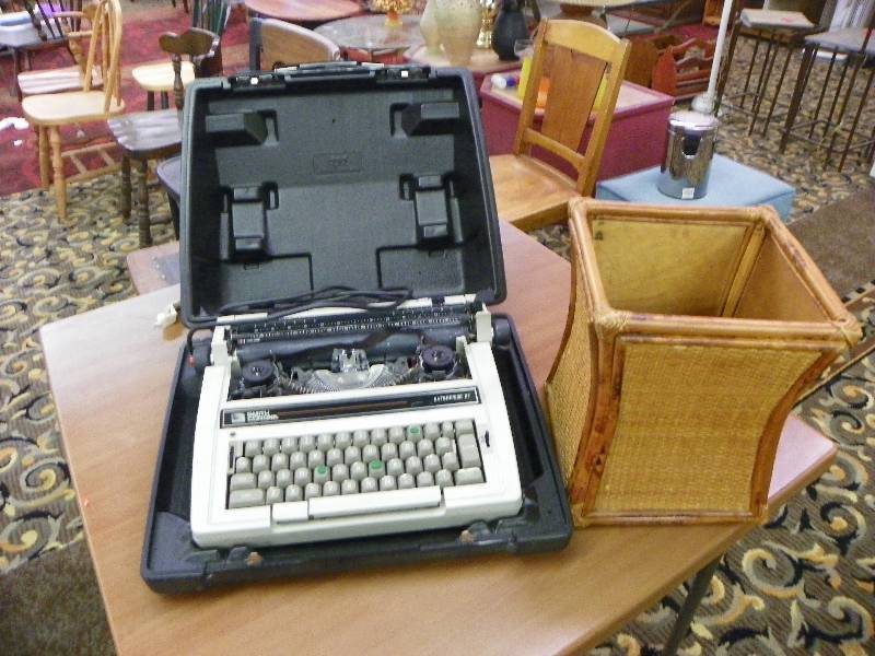 lot 85 image: Smith Corona electric typewrite in case and wicker waste paper basket