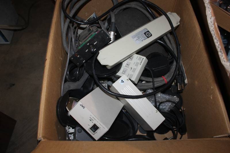 lot 153 image: Box Lot of Electronics Including JVC AC Adapter AA-P700, Power Strip, Joystick, Sony Remote Control SVRM-100A