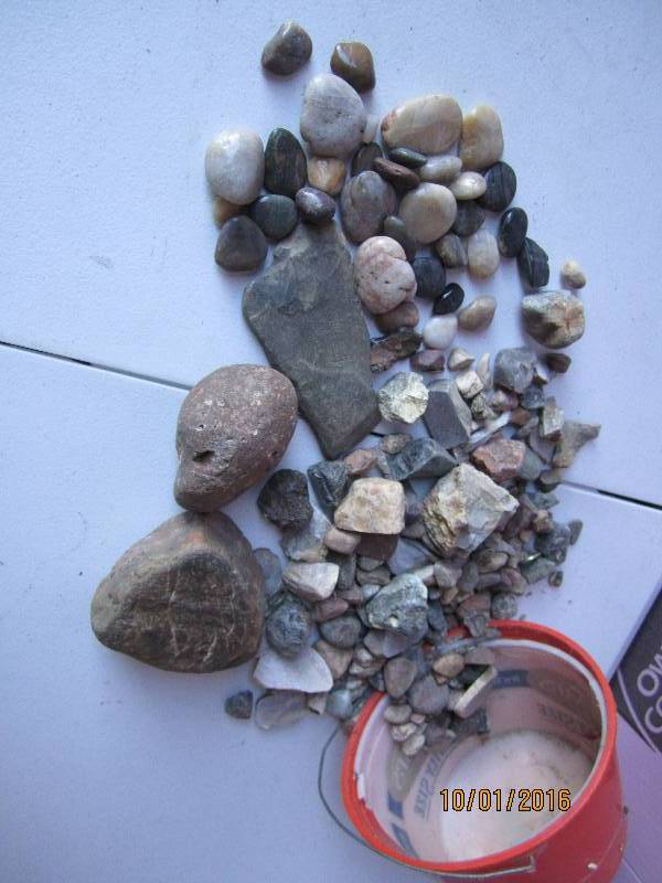 Bucket of rocks, including cut and ...