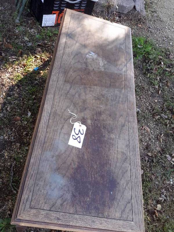 lot 38 image: Solid oak coffee table with intricate carved design on sides