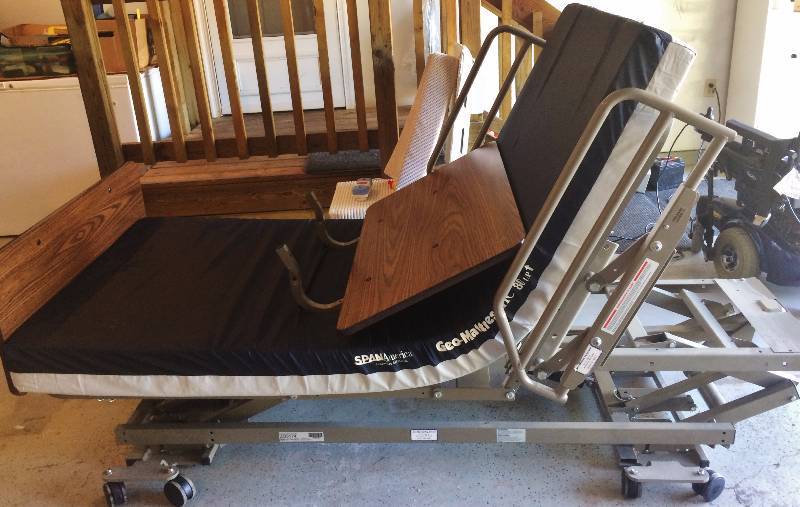 Zenith 6 Position Power Adjustable 500lb Capacity Long Term Home Care Power Hospital Grade Bed On Casters With Free Like New Mattress, Remote Control, Adjustable Assist Bars, Manual & Wood Grain HeadFootboards - Excellent Condition