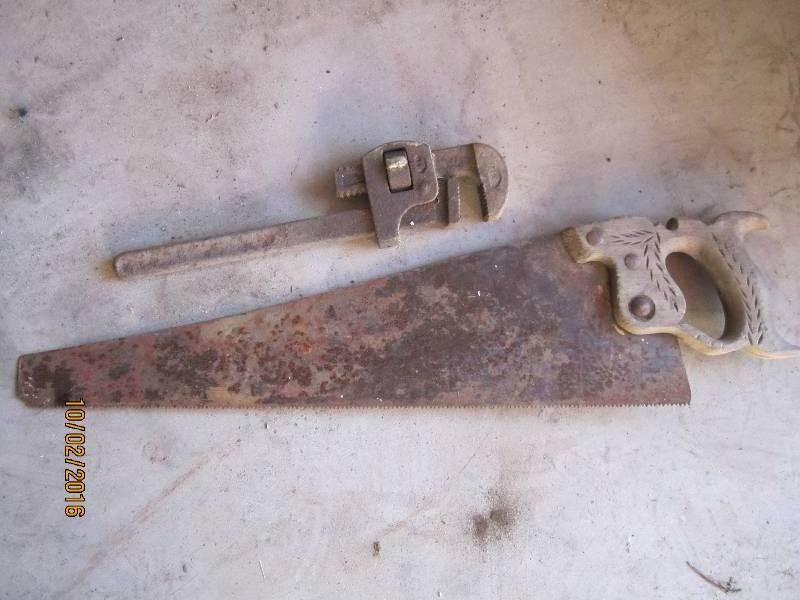 lot 63 image: Saw and pipe wrench...