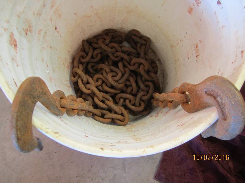 lot 93 image: Bucket of chain with hook ends...