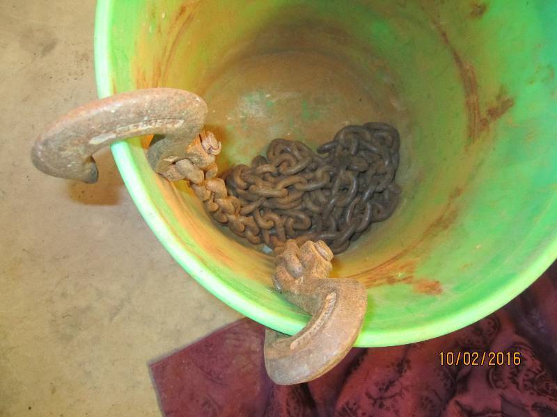 lot 99 image: Bucket of chain with hook ends...
