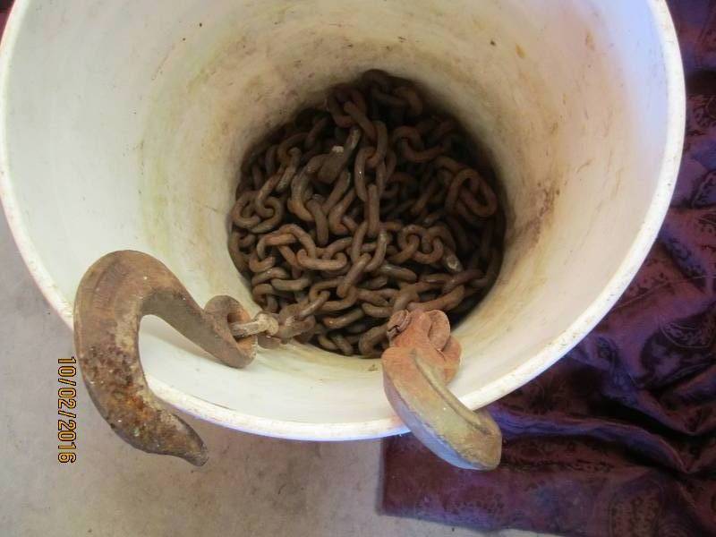 lot 100 image: Bucket of chain with hook ends...