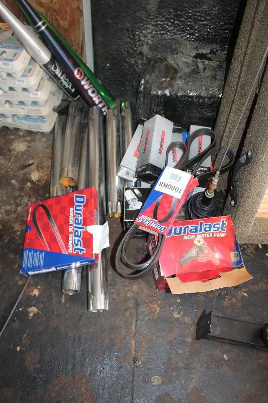 lot 104 image: Pile Lot of Parts Including Duralast Water Pump, Belts, Bosch Fuel Pumps, And More