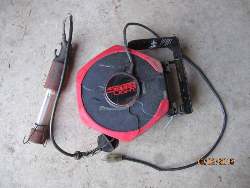 lot 47 image: Saber light retractible cord shop l...