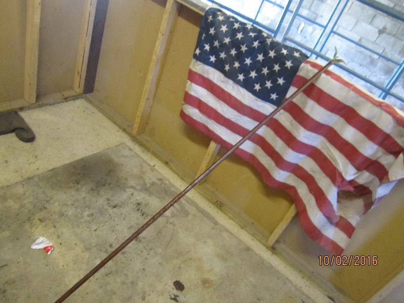lot 53 image: Torn US flag with pole...