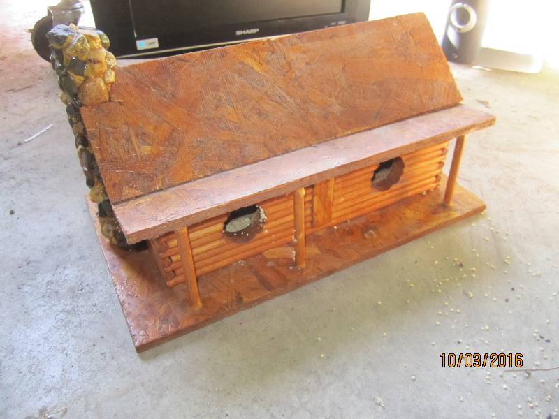 lot 93 image: Hand made log cabin bird house...