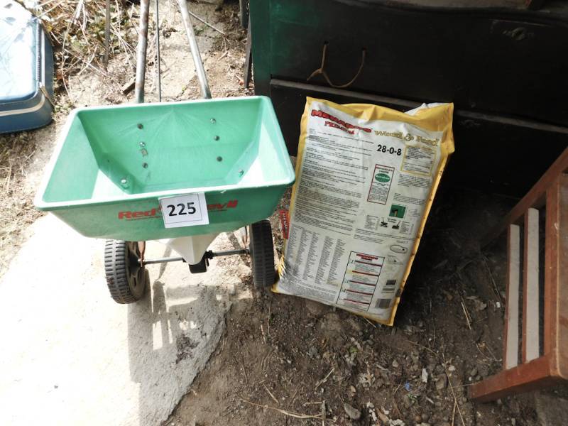 lot 225 image: bag of weed n feed spreader and tools