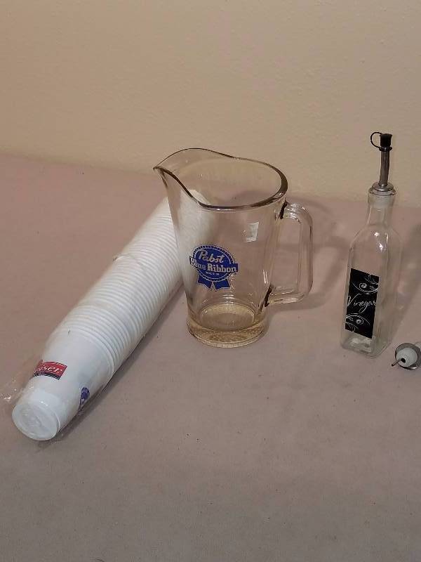 lot 122 image: Glass Pabst Blue Ribbon Pitcher, row of Budweiser cups and Glass Vinegar Bottle