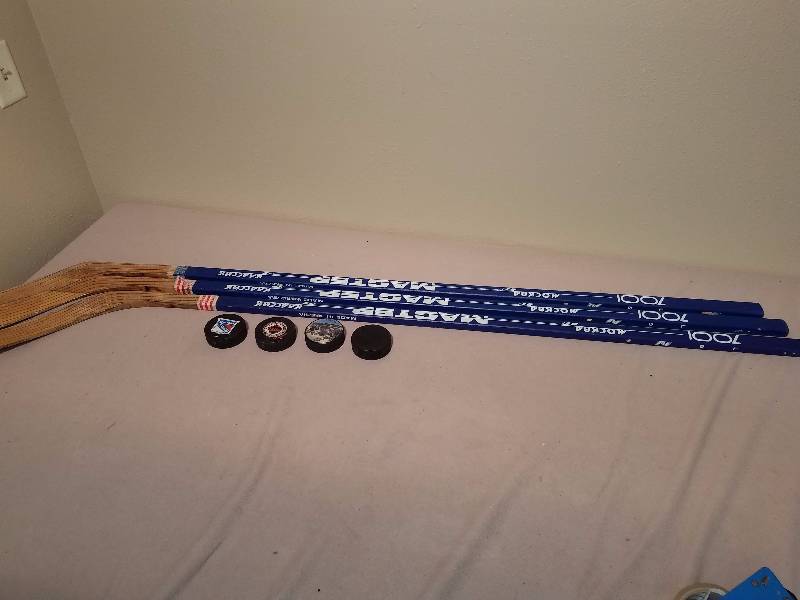 lot 185 image: 3 Master Hockey Sticks and 4 pucks
