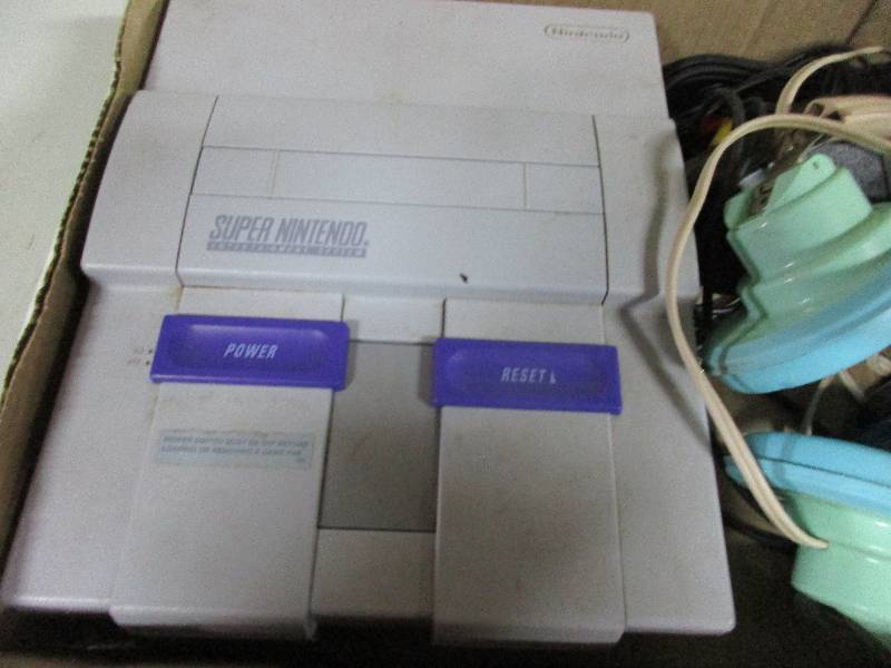 lot 102 image: Super Nintendo and headphones