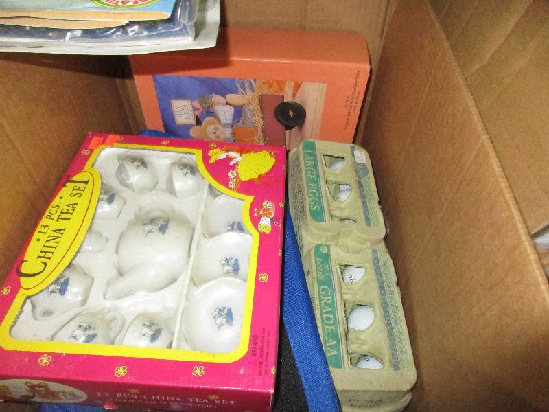 lot 136 image: dozen golf balls, tea set coloring books and dishes set