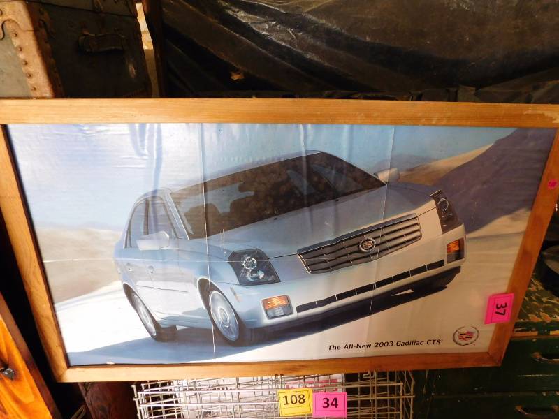 lot 37 image: Cadillac and Jurasic Park posters