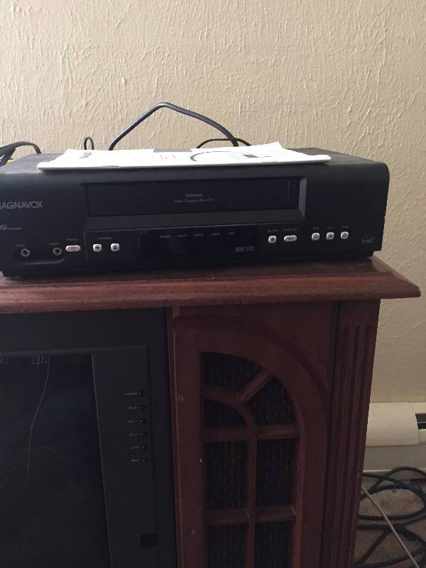 CONSOLE TV AND 2 DVD PLAYERS AND ONE VHS PLAYER