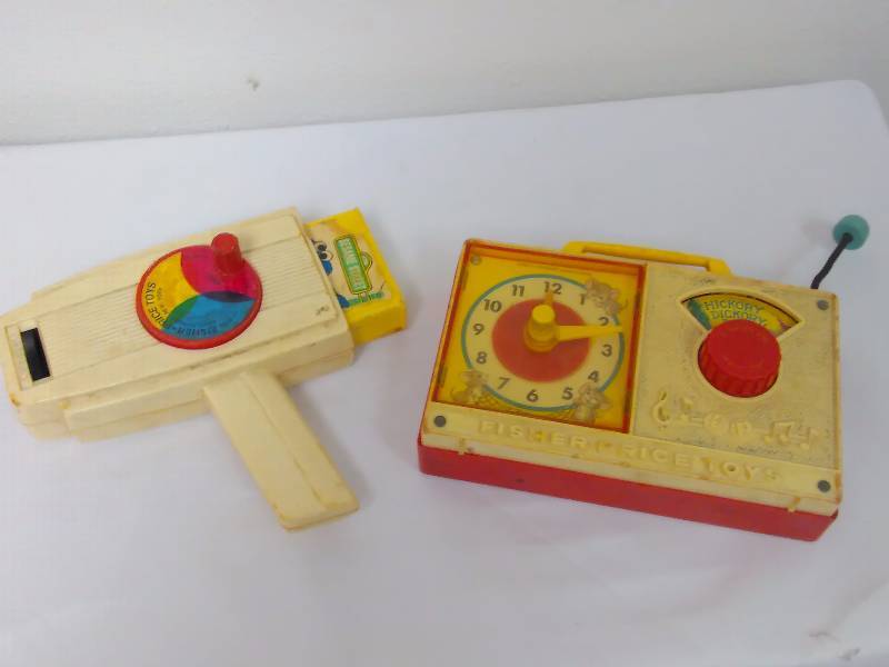 lot 20 image: Sesame Street Projector model 460, and Musical Fisher Price, musical hickory dickory dock, model 107 in working condition