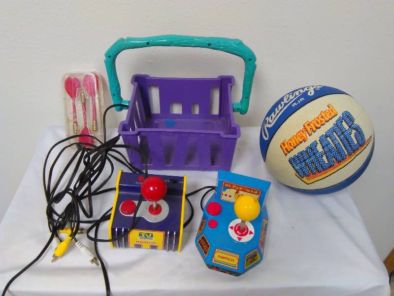 lot 126 image: Ms Pac Man TV game by Namco with 2 controllers and hook ups, Rawlings Basketball from Honey Frosted Wheaties and three (3) sets of competitive darts.