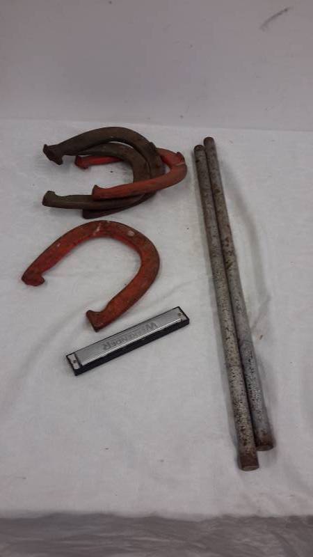 lot 131 image: Horseshoes and harmonica