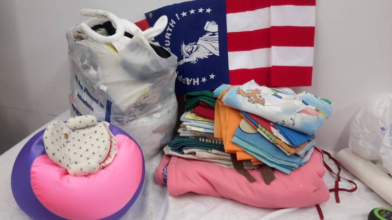 lot 156 image: Aprons, linens, flag, bean chair, bedding and costumes