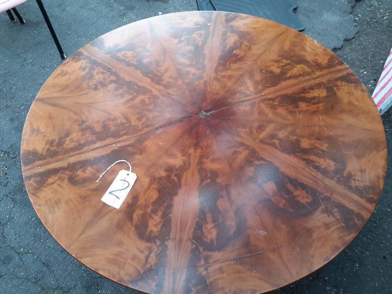 lot 2 image: 48in Diameter x 17 in h.  Tilt top WALNUT burled Coffee table with 3 claw foot legsfeet.. On rollers.s