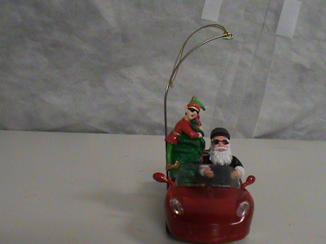 lot 104 image: Santa in Race Car Tree Ornament