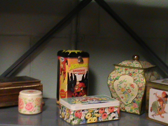 lot 200 image: Antique storage tin, round tin with candle with roses on it