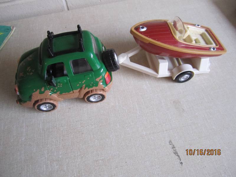Toy vehicle with boat and trailer...