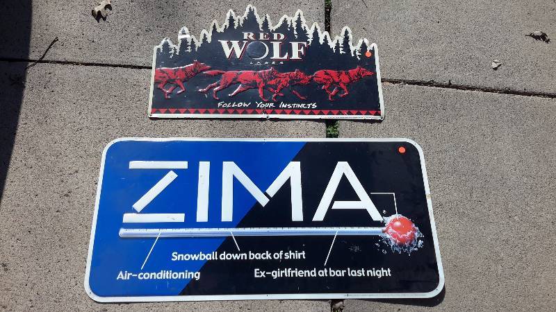 Aluminum Red Wolf Lager sign and Zima thermometer sign.