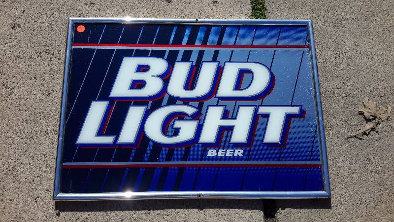 A framed Bud Light mirror sign