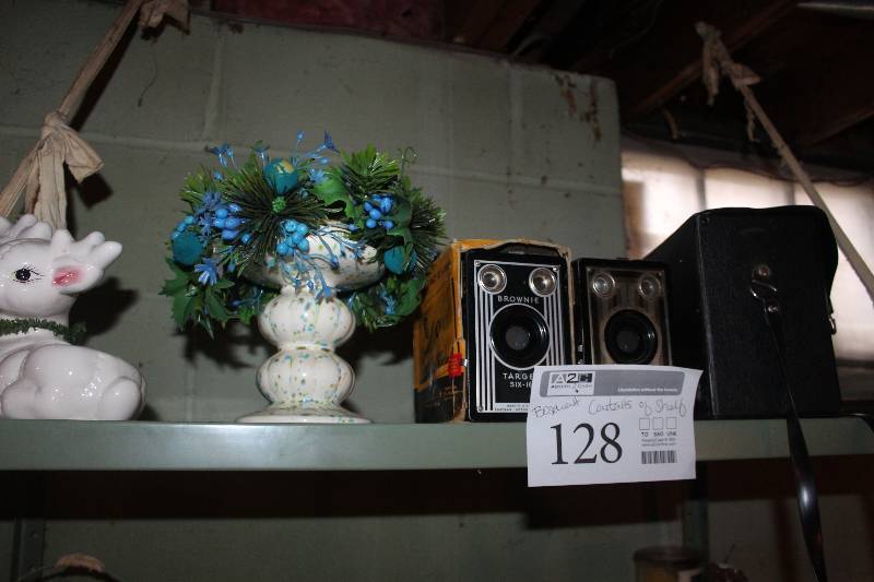 Contents of Shelf Including Decorations, Polaroid Land Camera, Brownie Target Six 16 Camera