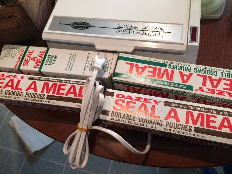 lot 75 image: Miscellaneous Kitchen Lot - Vintage Tupperware, SealAMeal, Silverplate Flatware, Vintage Fryryte Deep Fryer Etc