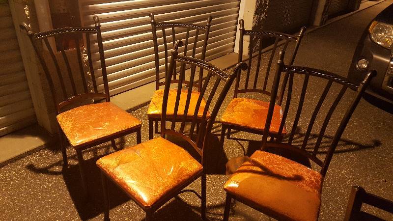 Six cast iron chairs with glass patio table