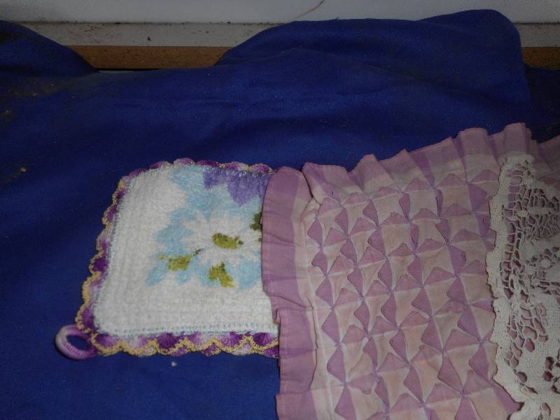 lot 103 image: HANDCRAFTED DOILIES AND DOLL DRESSES
