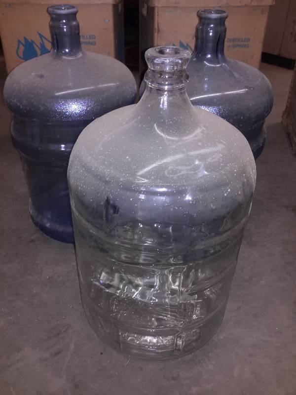 1 Glass 5 Gallon water jug.. 2, plastic 5 gallon jugs.. Boxes included