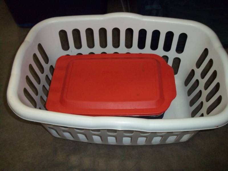 Clothes Basket with 2 Pyrex baking dishes with covers
