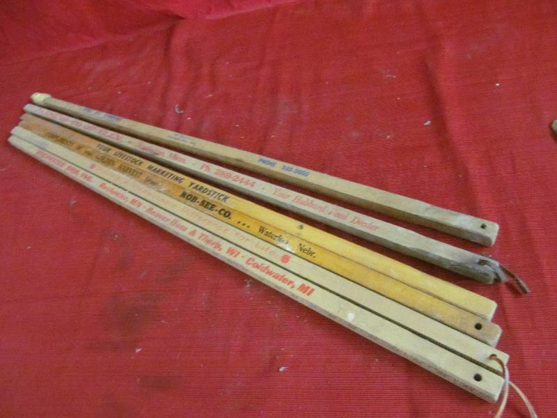 vintage square advertising yard sticks